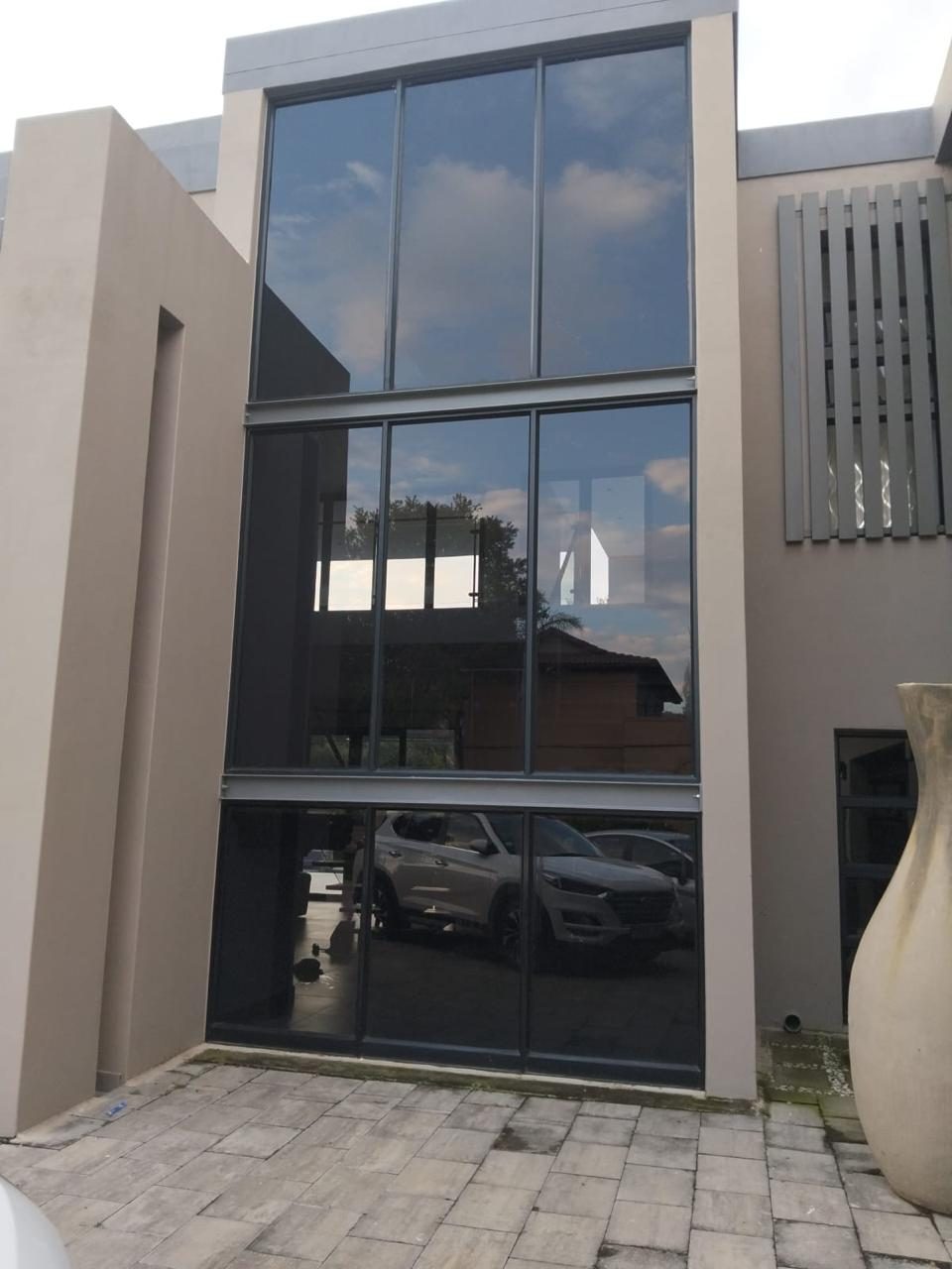 Three-storey commercial glass facade with dark Nanoshade solar film