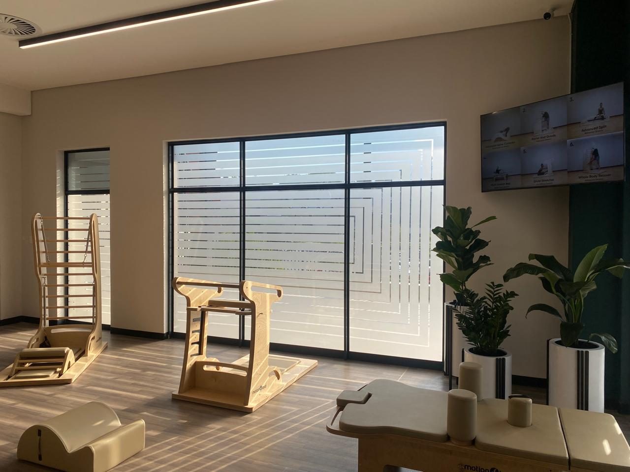 Nanoshade frosting film applied wall-to-wall on a Pilates studio for daytime privacy without losing natural light